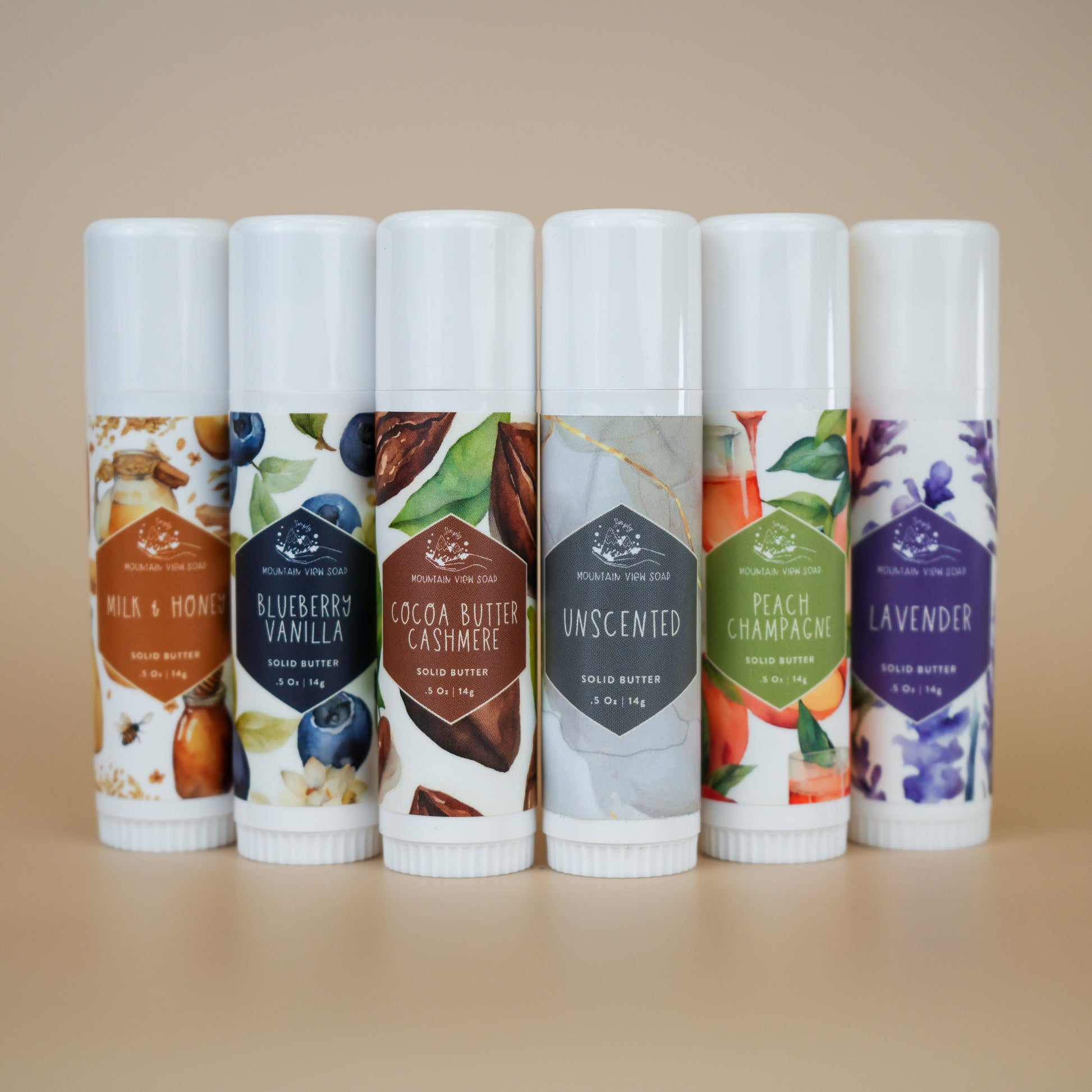 six standing tubs of solid body butter sticks in different mountain view soap scents to choose one for your order